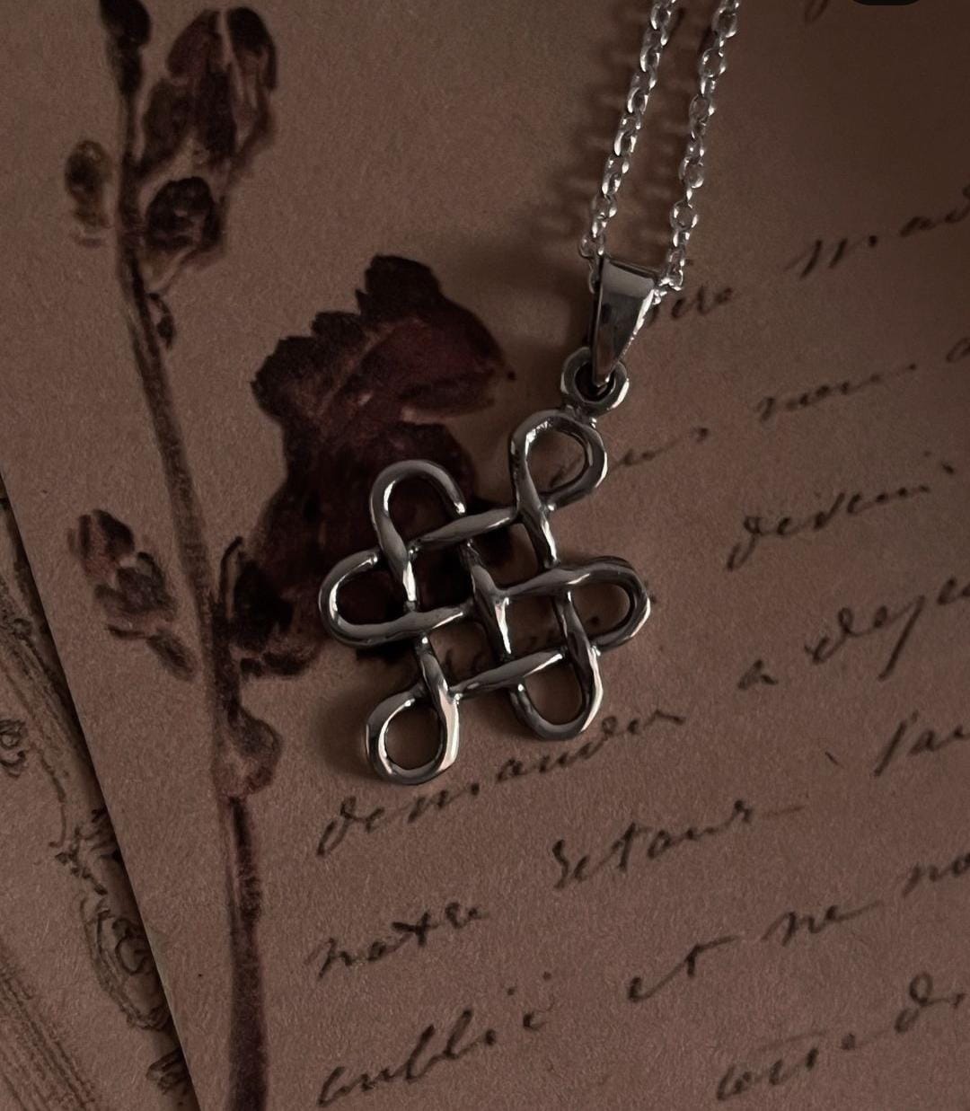 Exquisite big karma Celtic knot pendant in sterling silver with detailed craftsmanship.