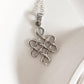 Timeless Celtic knot silver pendant with a large karma symbol.