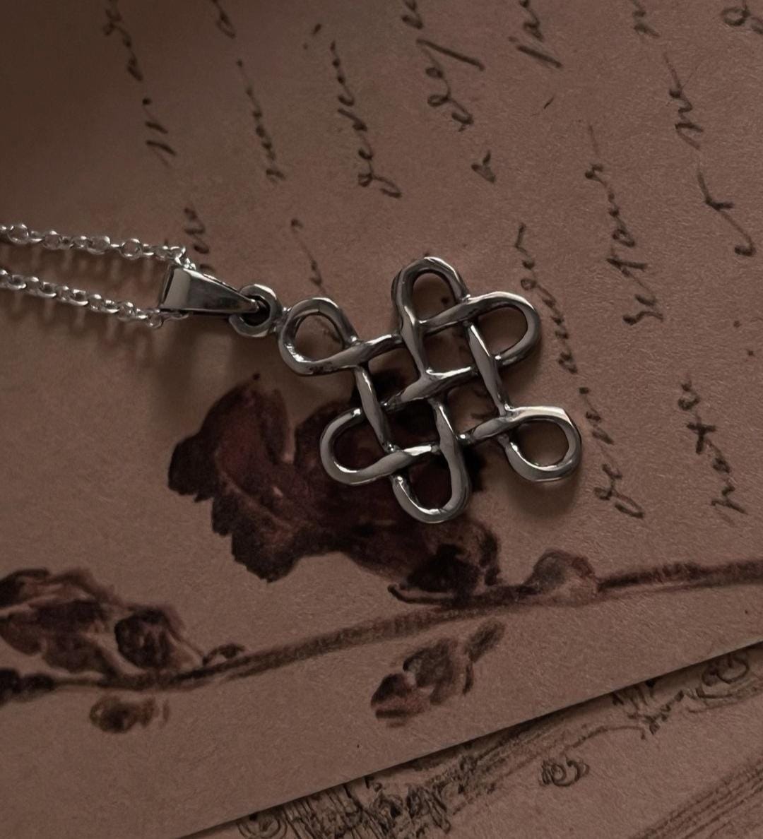 Elegant big Celtic knot pendant with a karma symbol in sterling silver.