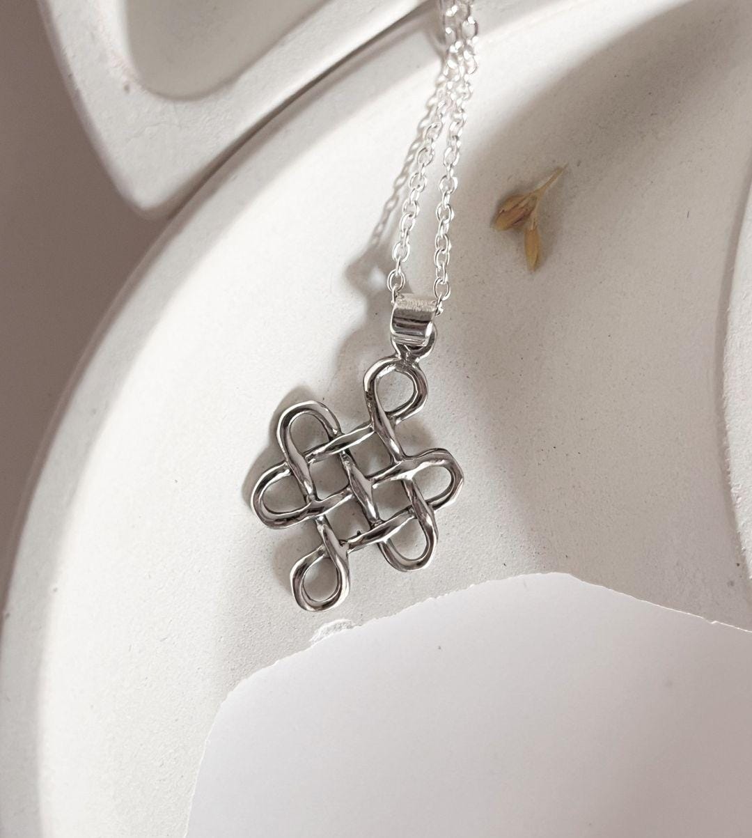 Unique big karma Celtic knot silver pendant for a spiritual statement.