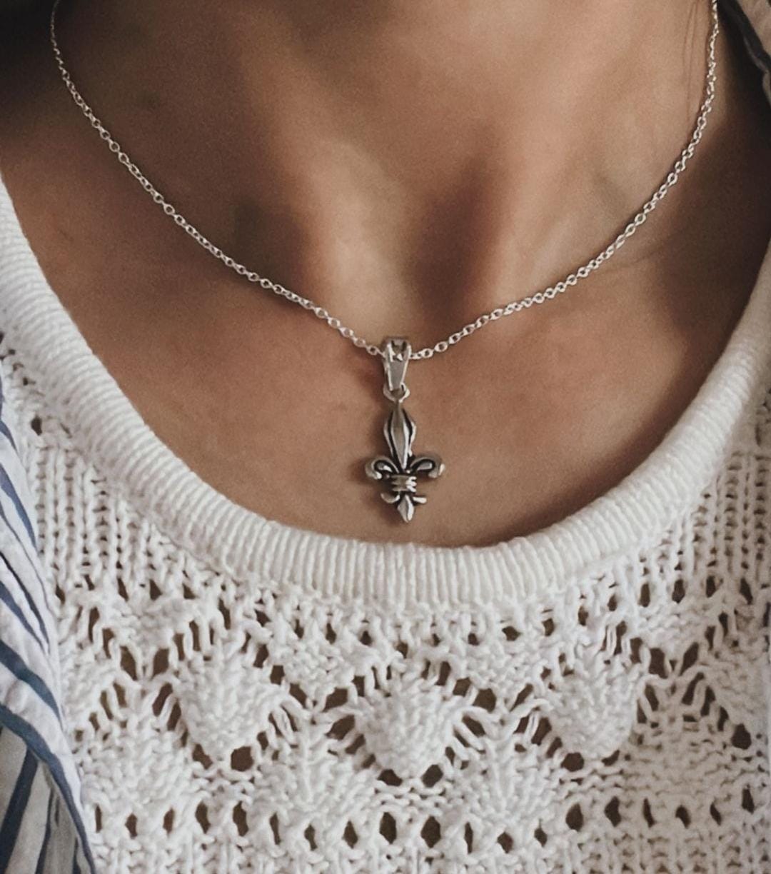 Handcrafted Fleur De Lis silver pendant with a smooth, refined finish
