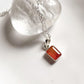 Close-up of carnelian rectangle pendant hanging from silver chain