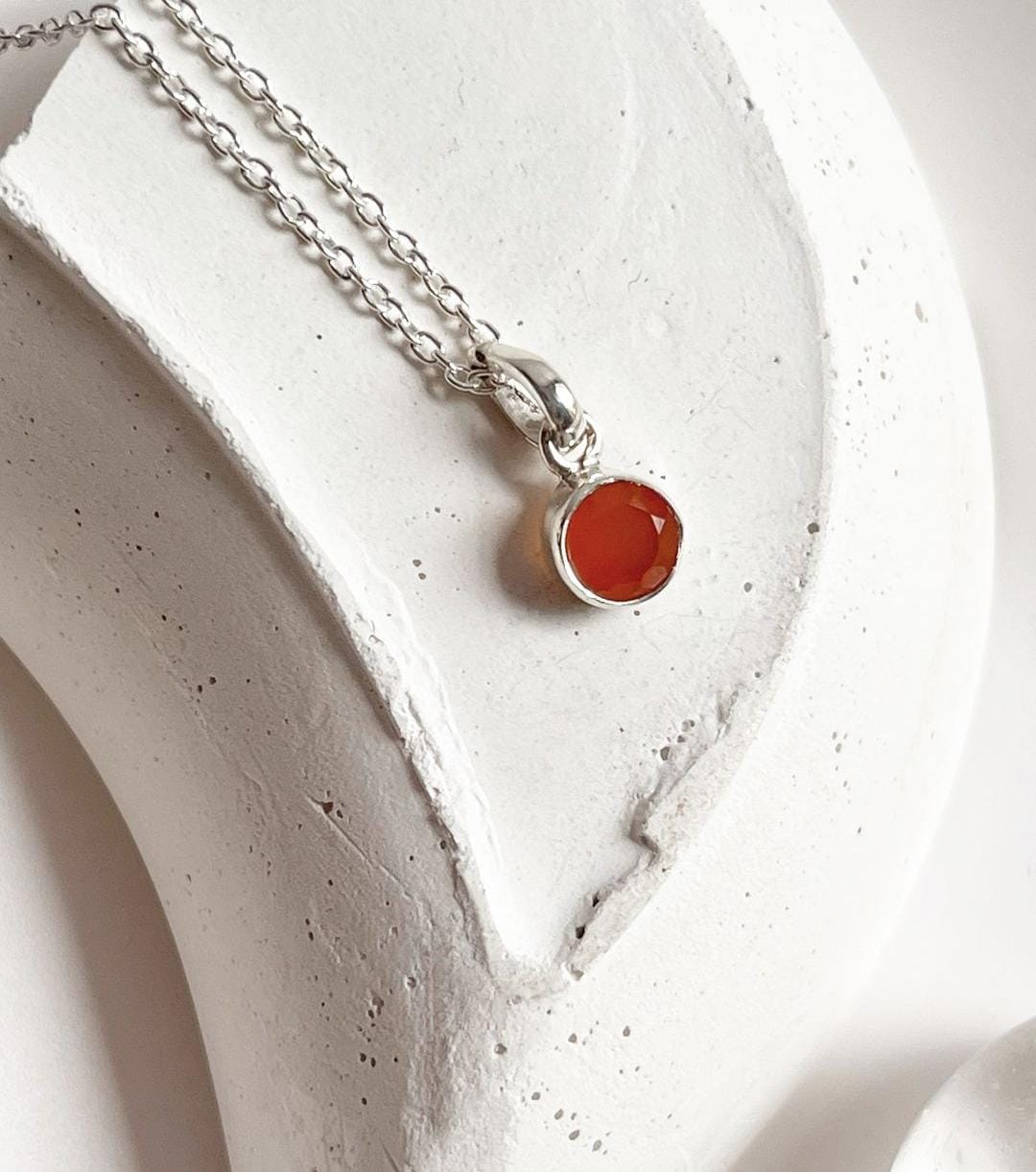 Elegant round carnelian pendant with polished silver setting