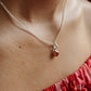 Smooth carnelian round pendant with simple silver design