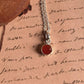 Carnelian round pendant with a delicate silver border