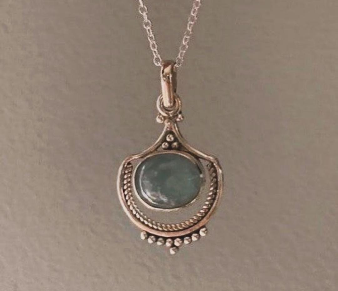 Unique aquamarine silver pendant with boho flair and intricate design.