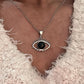 Elegant black onyx evil eye pendant with sterling silver detailing.