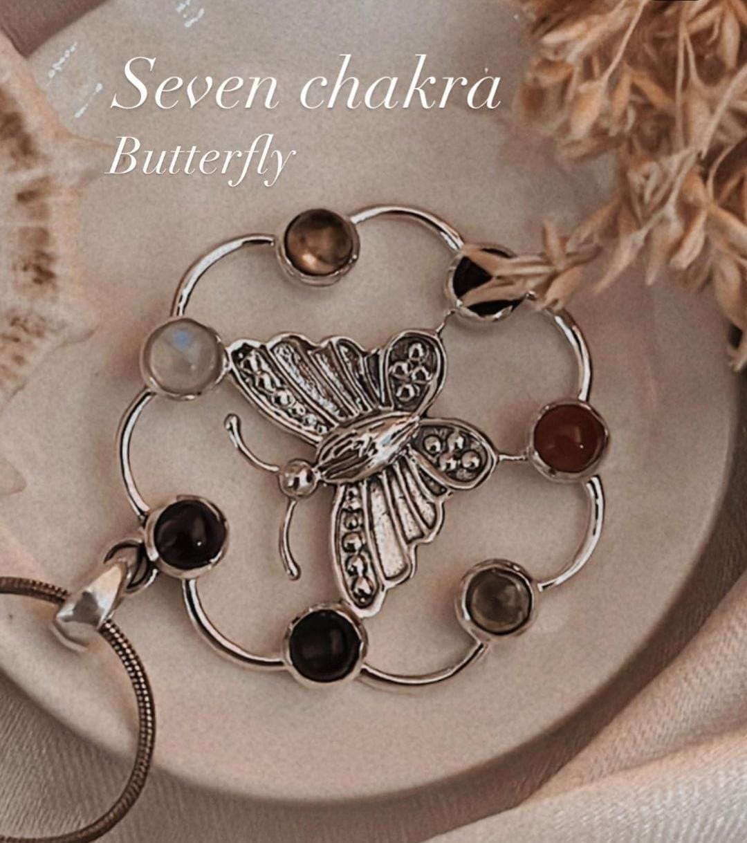 Sterling silver pendant featuring butterfly design and seven chakra stones