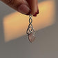 Elegant rose quartz pendant featuring a trinity knot design