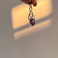 Amethyst gemstone set in a silver trinity knot pendant.