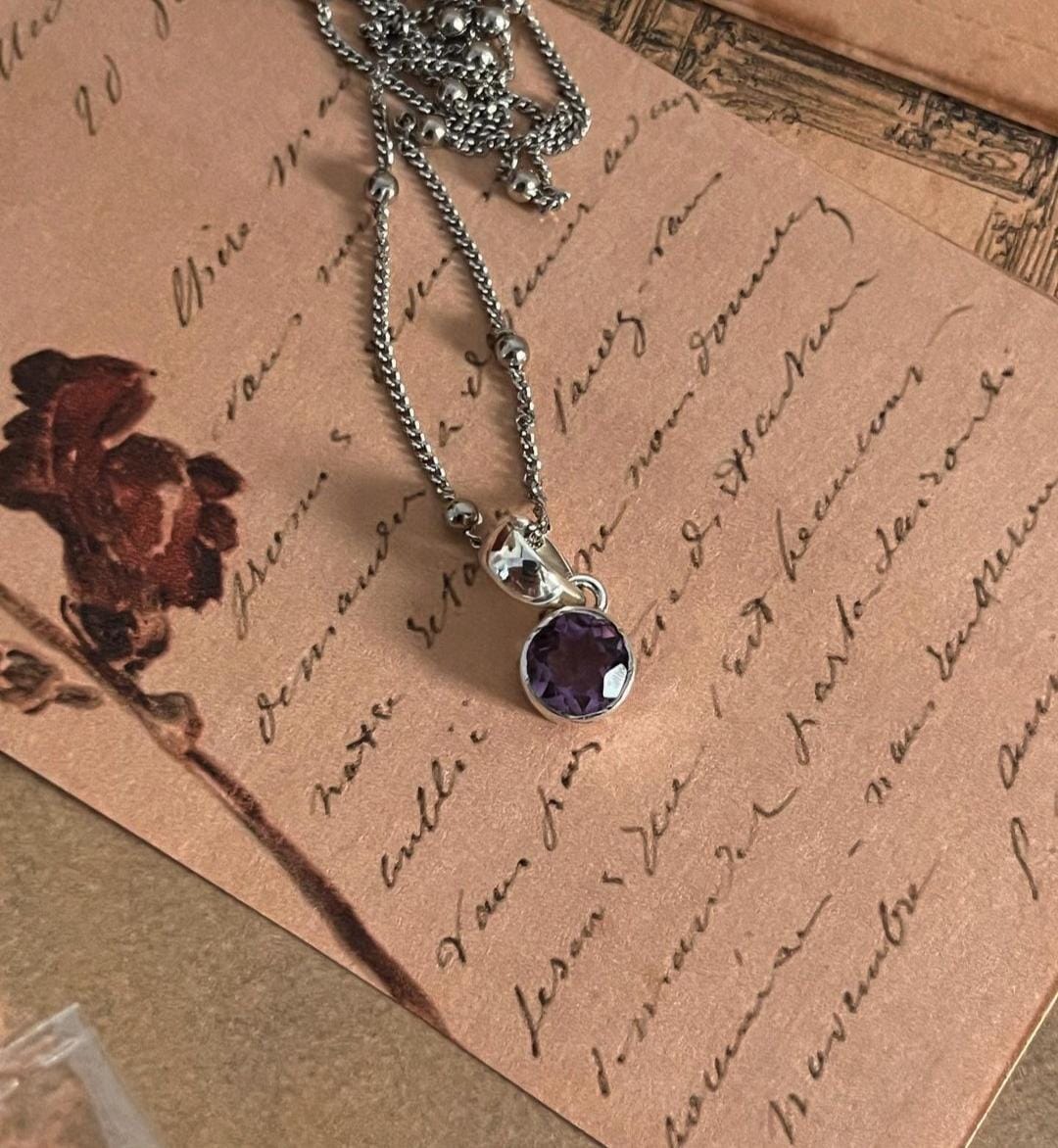 Silver Pendant Featuring Round Cut Amethyst Gem