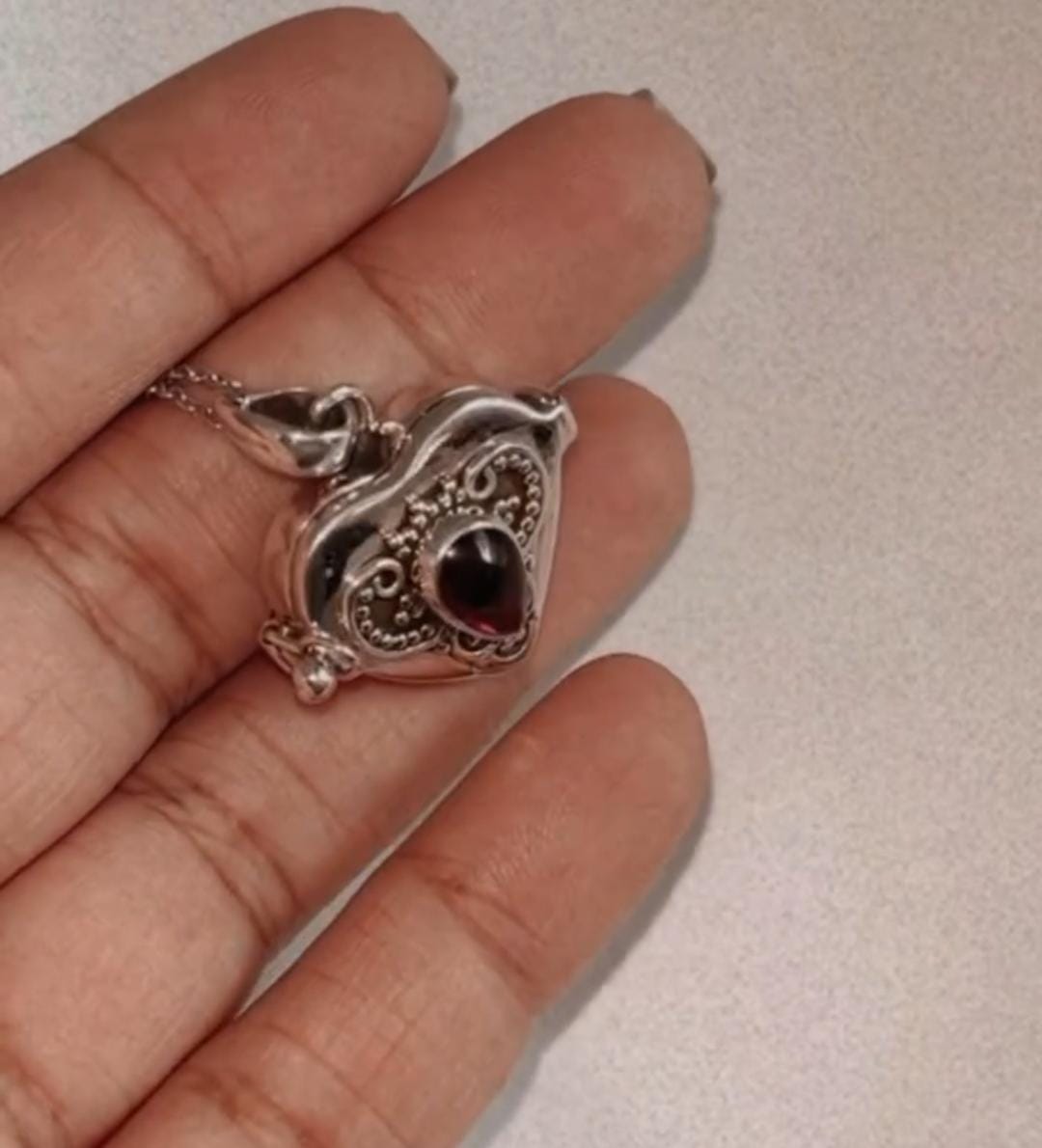 Garnet heart vintage storage pendant with intricate silver detailing