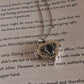 Elegant silver pendant with garnet heart and secret storage feature