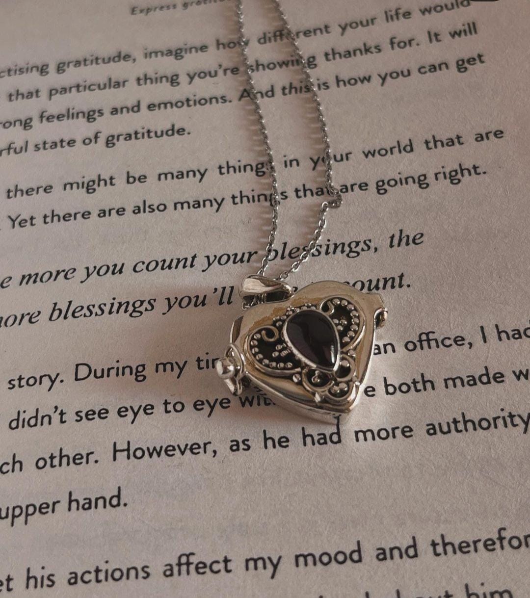 Elegant silver pendant with garnet heart and secret storage feature