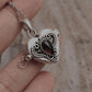 Vintage silver pendant with a garnet heart and concealed storage space