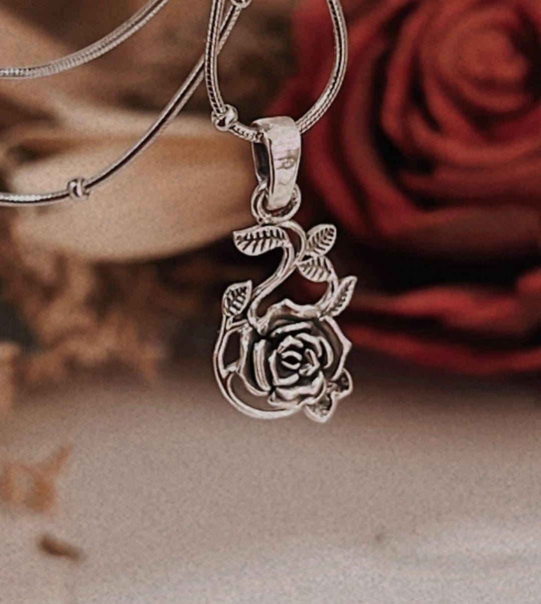 Antique-inspired rose silver pendant