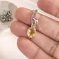 Close-up of citrine pear cut gemstone set in a silver pendant