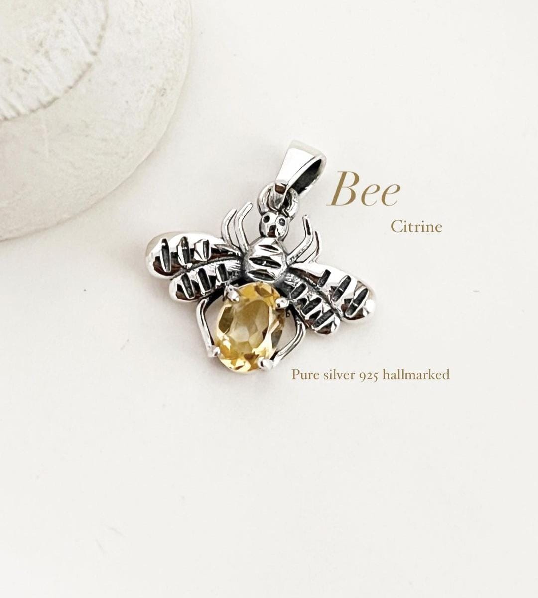 Charming bee design citrine silver pendant with vibrant gemstone.