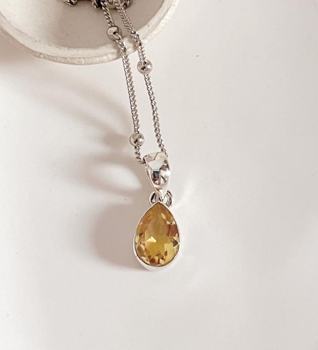 Stylish silver pendant featuring a pear cut citrine gemstone