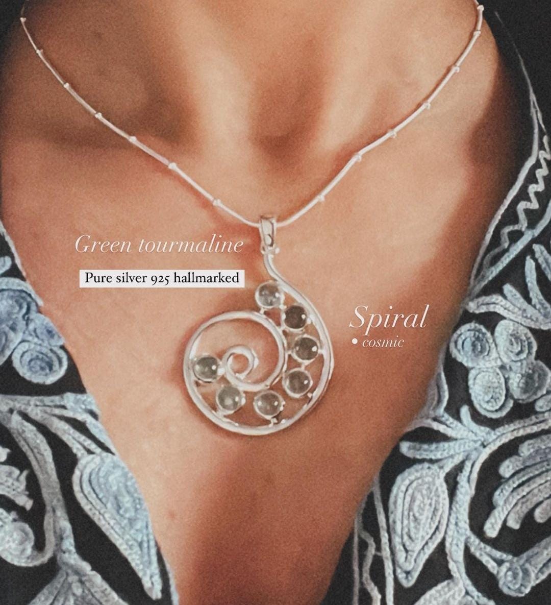 Stylish green tourmaline gemstone pendant with spiral silver setting