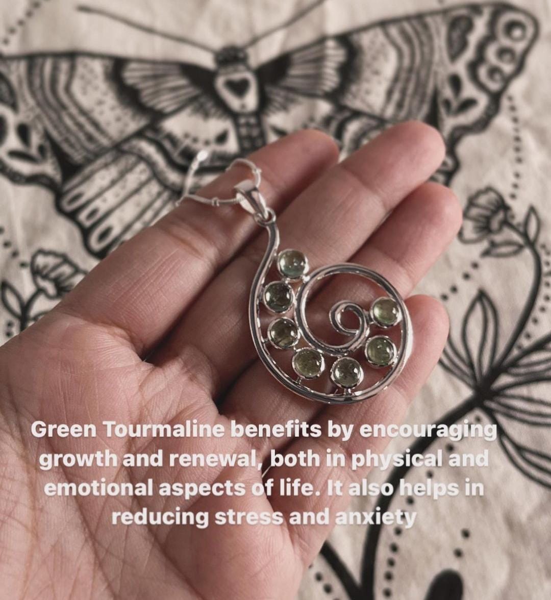 Elegant spiral design green tourmaline pendant set in silver