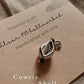 Delicate cowrie shell charm silver pendant with polished finish