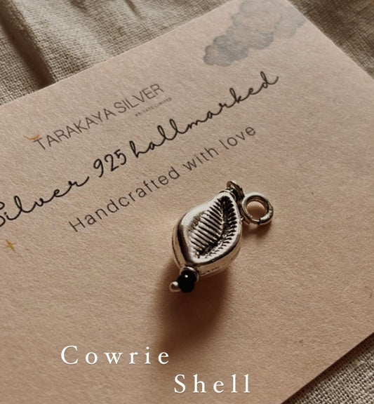 Delicate cowrie shell charm silver pendant with polished finish