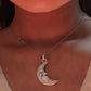 Close-up of big crescent moon pendant in fine silver