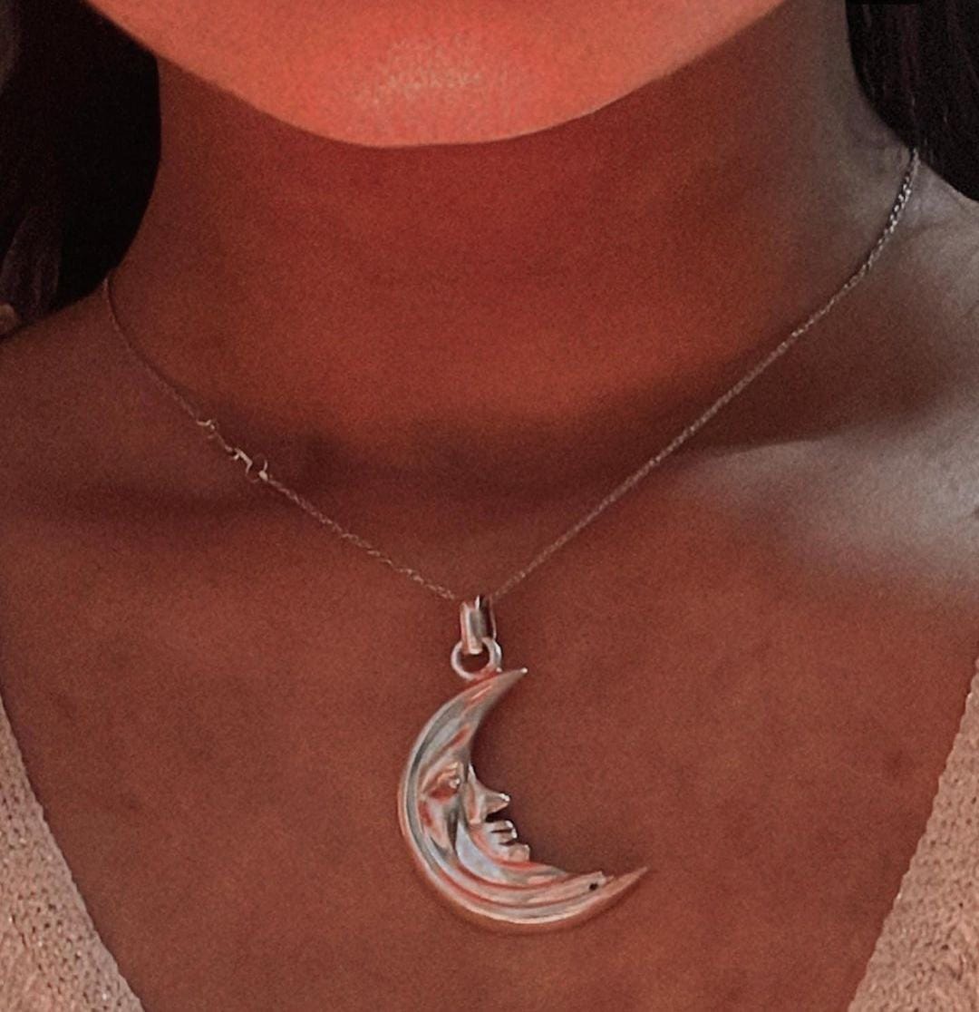 Close-up of big crescent moon pendant in fine silver