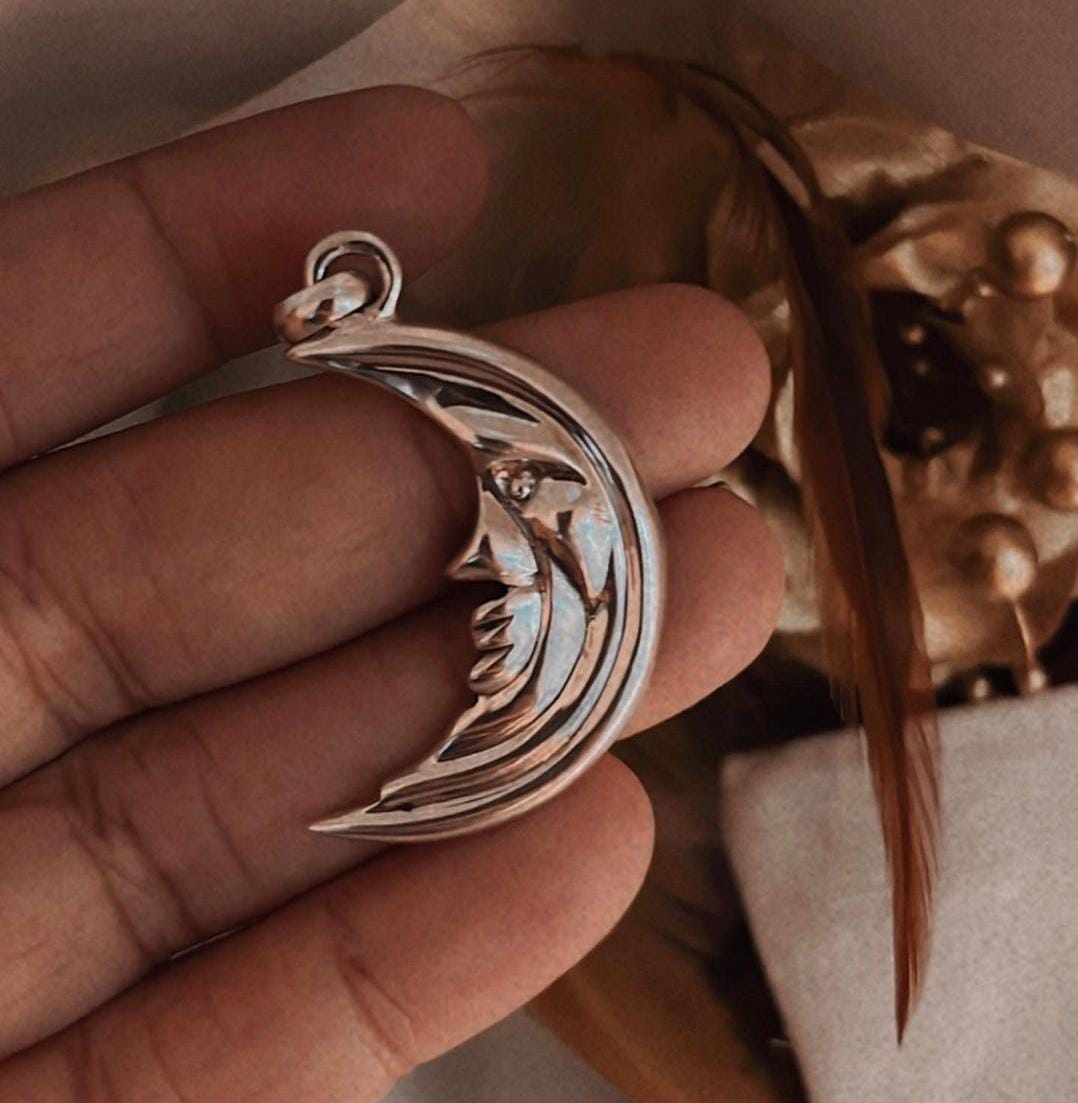 Bold crescent moon shaped silver pendant with polished shine