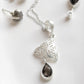 Intricate Celtic knot silver pendant with smokey quartz stone