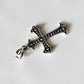 Close-up of cross silver pendant with intricate detailing
