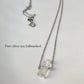 Close-up of clear quartz pencil crystal necklace with minimalist design