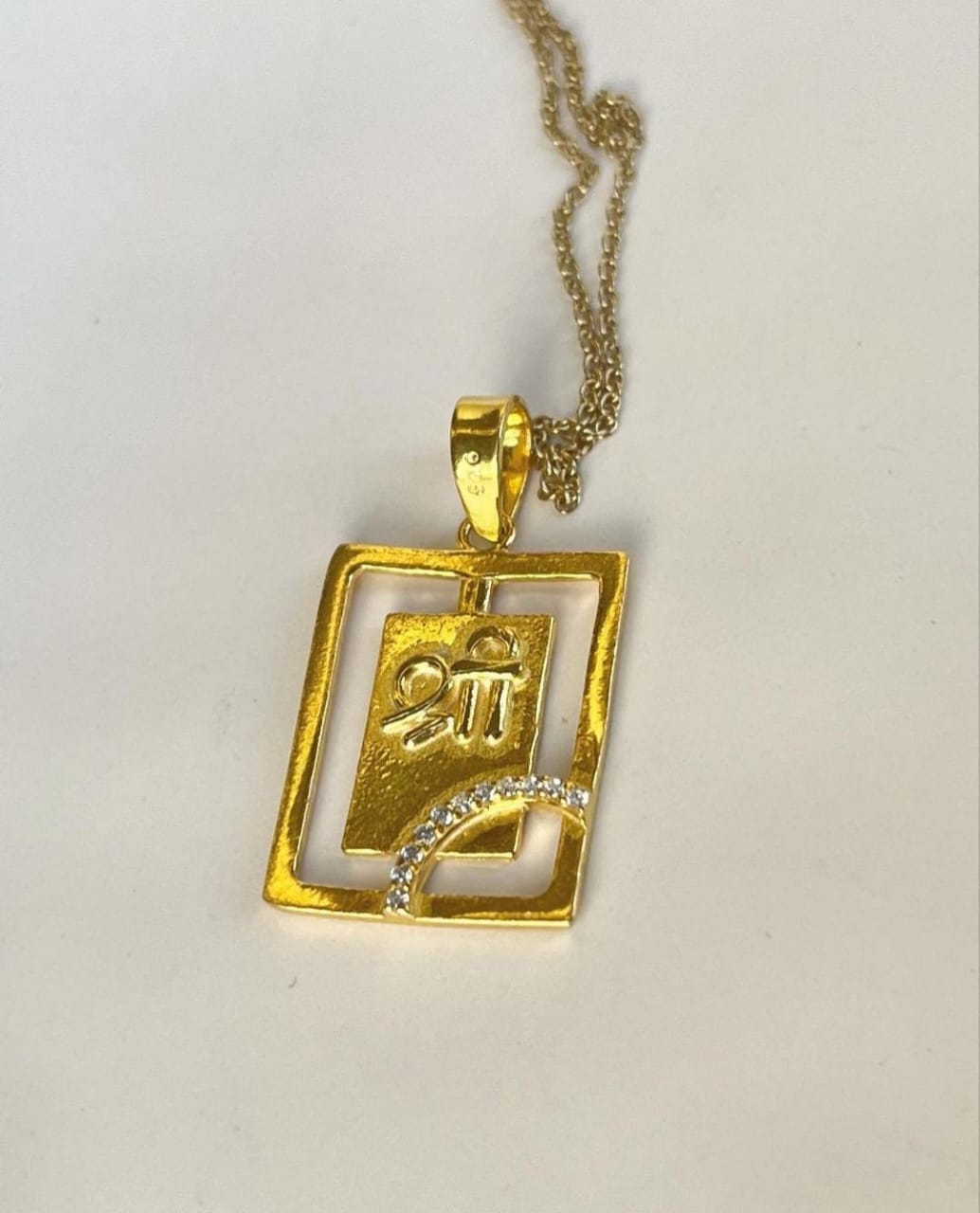 Handcrafted Shree pendant in gold plated silver with CZ stones