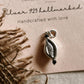 Close-up of cowrie shell charm in sterling silver pendant