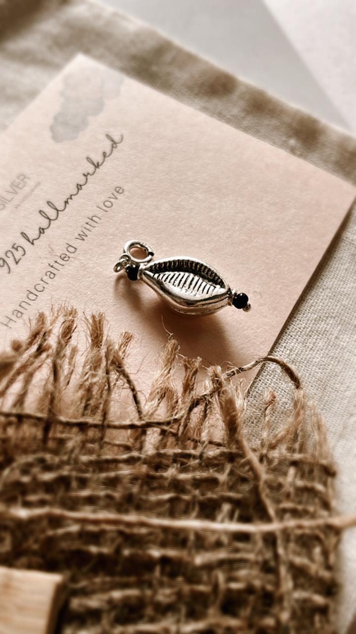 Nature-inspired silver pendant with a genuine cowrie shell charm