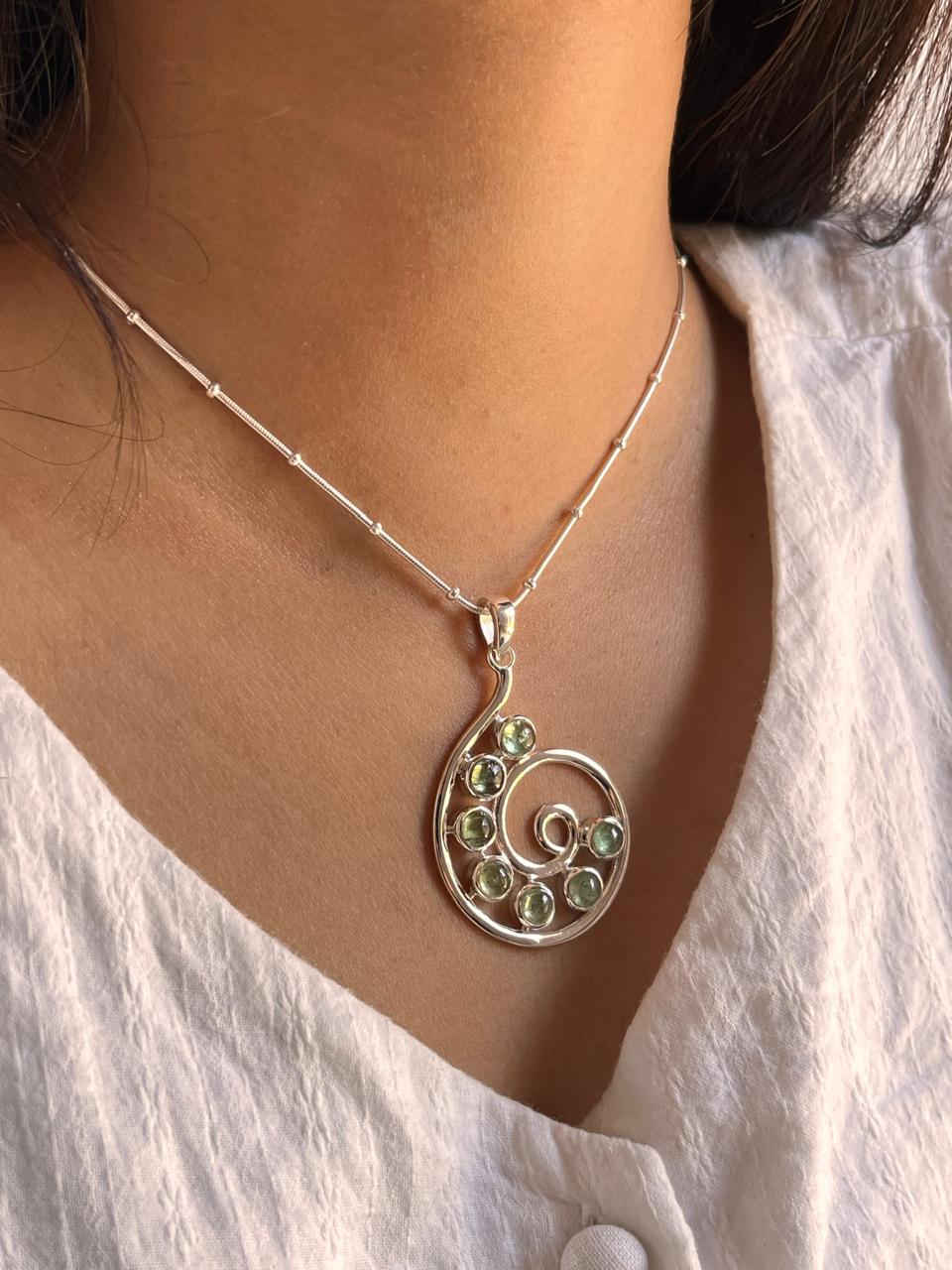 Charming green tourmaline spiral-shaped pendant in silver