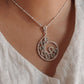 Unique green tourmaline spiral pendant with silver detailing