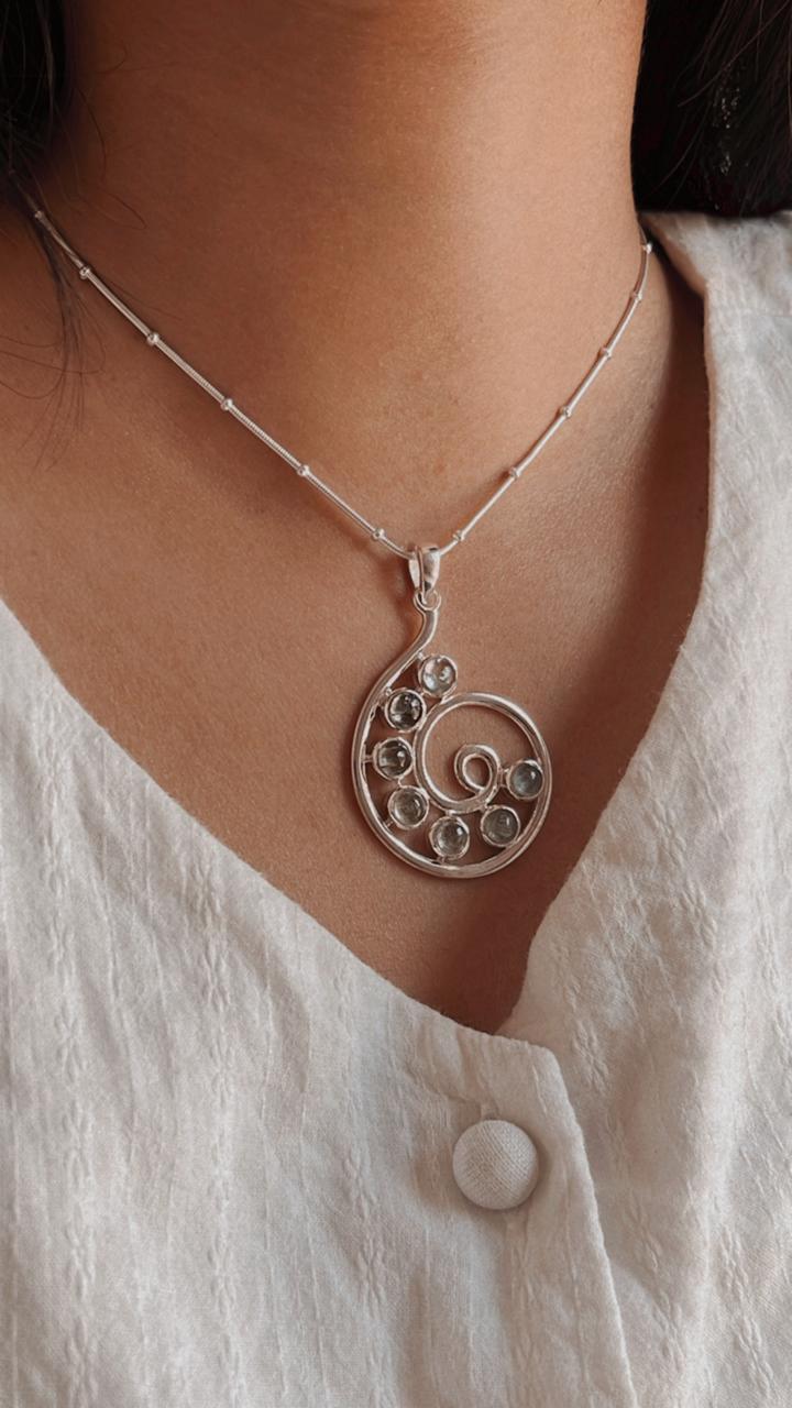 Unique green tourmaline spiral pendant with silver detailing
