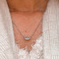 Close-up of evil eye shape CZ silver pendant with intricate design