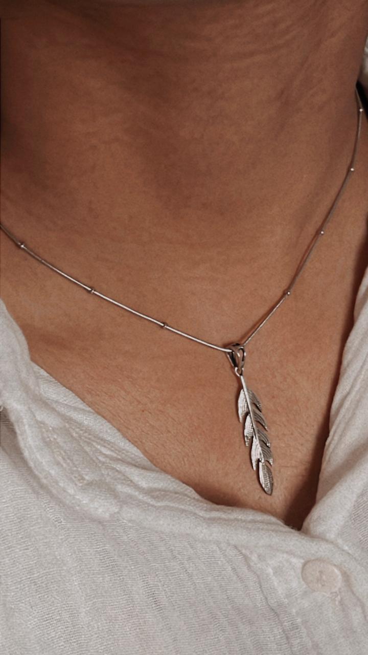Elegant feather silver pendant with delicate detailing and polished finish