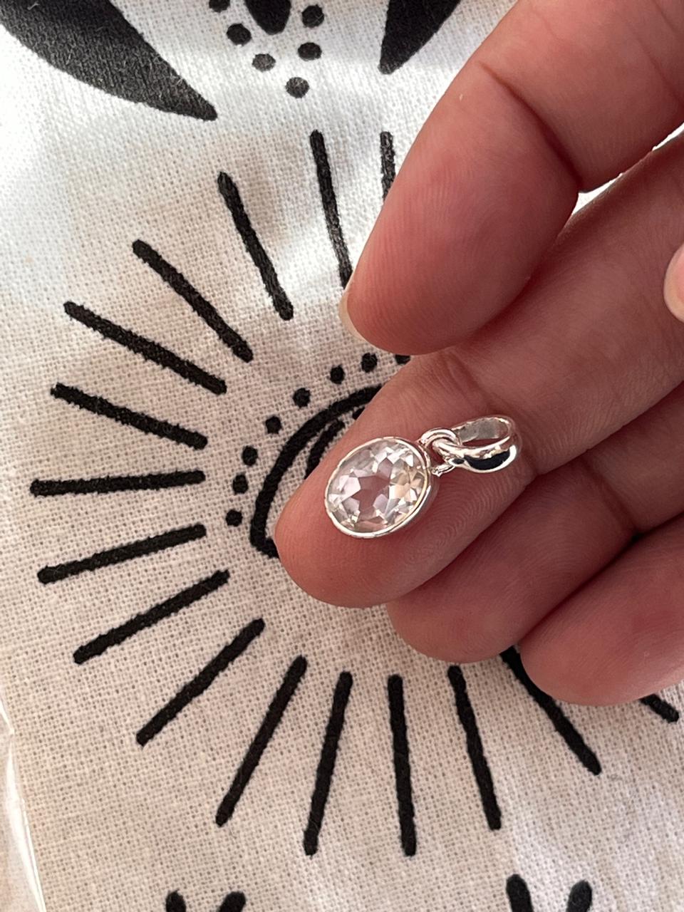 Clear quartz oval cut silver pendant with sleek, polished design