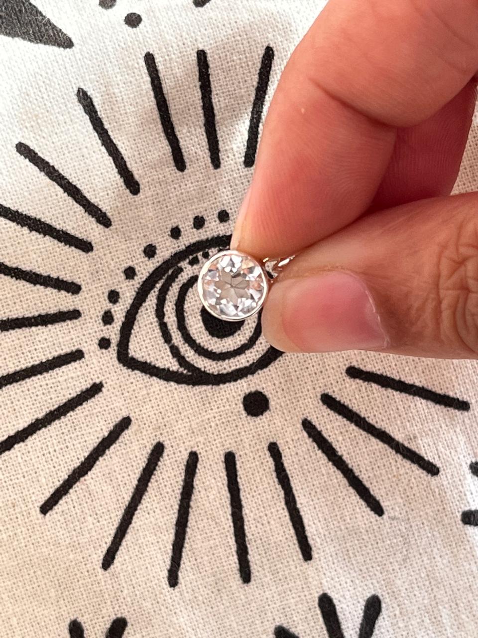 Elegant round cut clear quartz gemstone set in a silver pendant