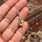 Close-up of citrine cross solitaire pendant with silver chain