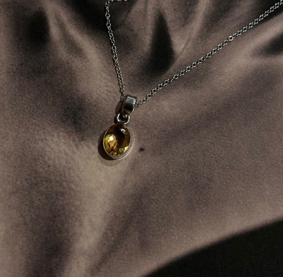 Stylish silver pendant featuring a 7mm oval cut citrine gemstone