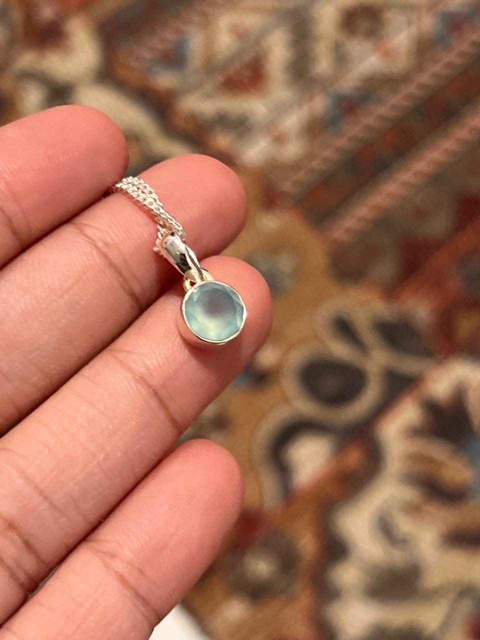 Sleek silver pendant featuring a round aqua chalcedony stone.