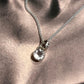 Clear quartz round cut gemstone pendant with smooth silver setting