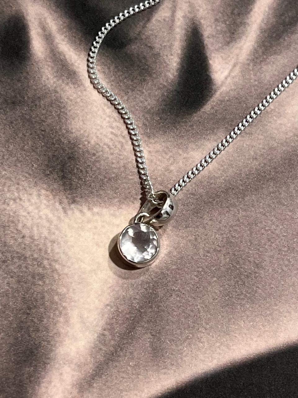 Clear quartz round cut gemstone pendant with smooth silver setting