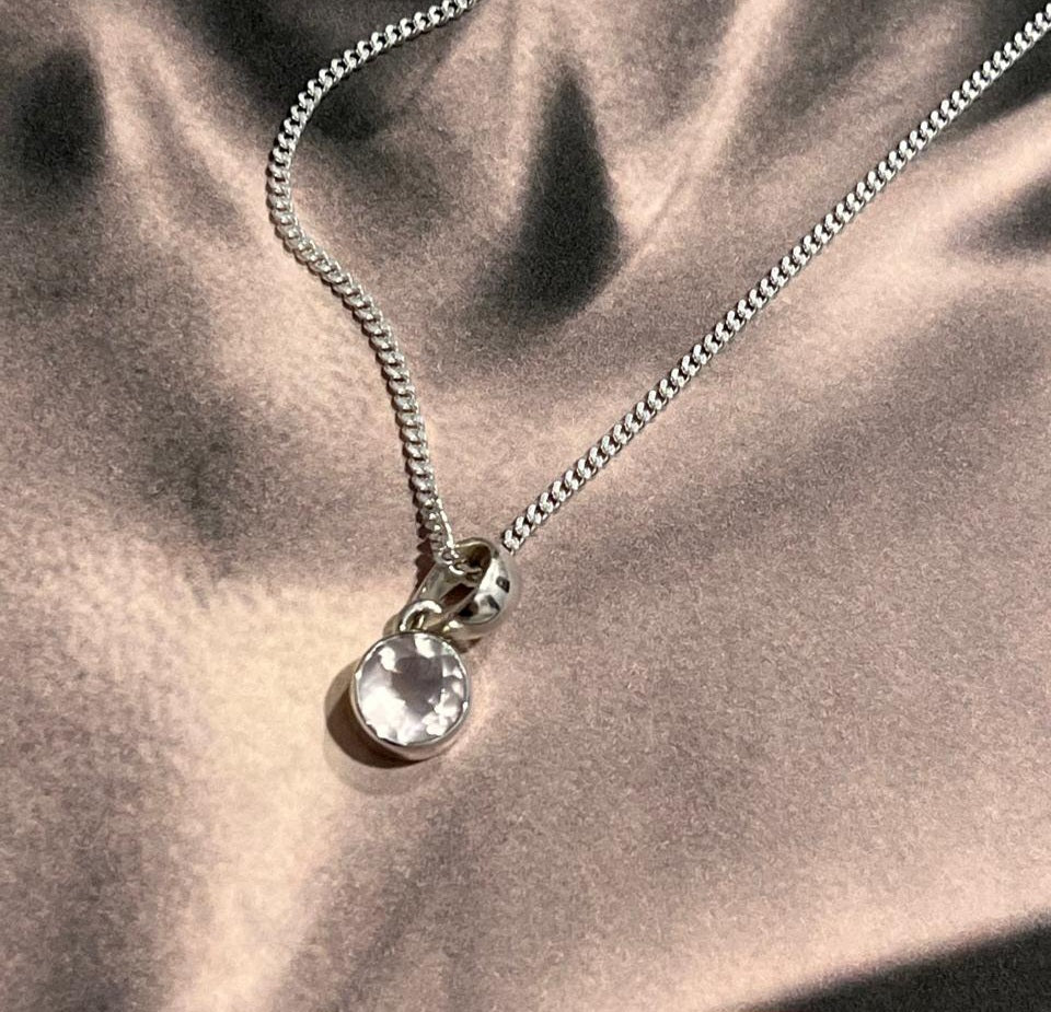 Clear quartz round cut silver pendant with refined, minimalist design