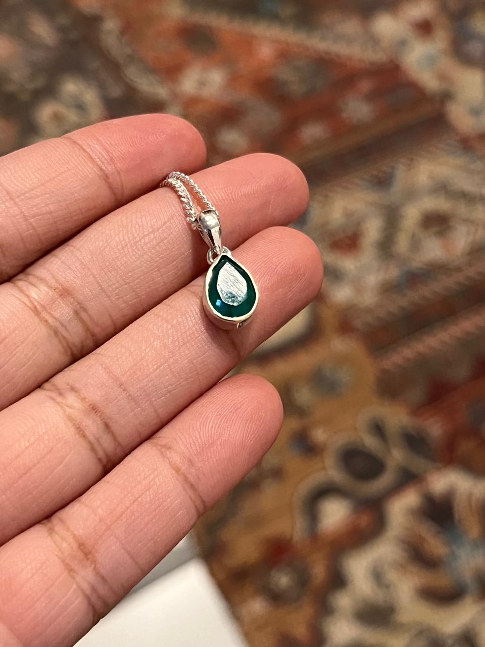 Sterling silver pendant featuring a green onyx pear stone